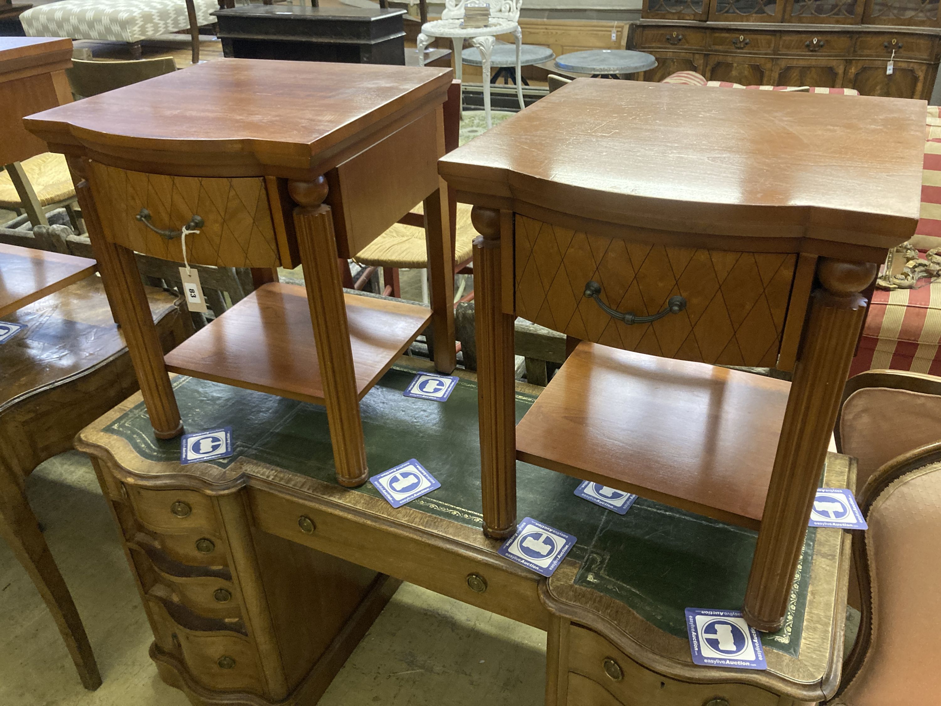 A pair of walnut bowfront two tier bedside tables, width 50cm, depth 50cm, height 61cm